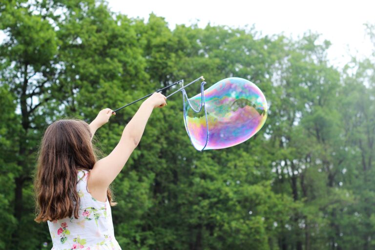 girl playing with a big bubble