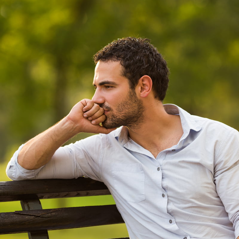 man on bench thinking